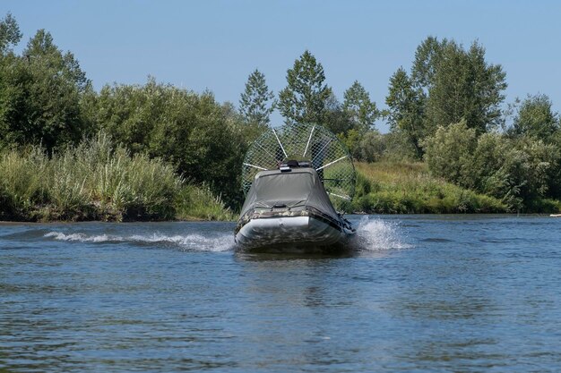 Montar a alta velocidad en un hidrodeslizador en el río en un día de verano con salpicaduras y olas