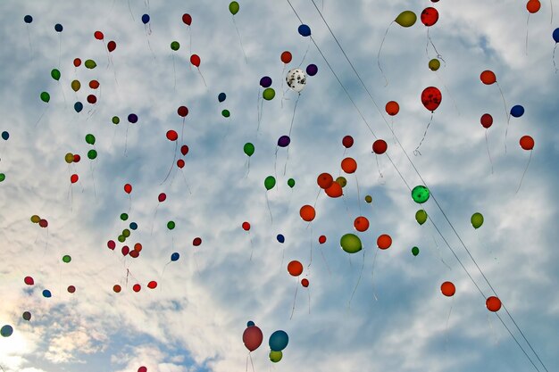 Un montón de globos multicolores en el cielo azul