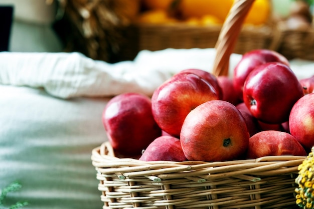 Un montón de manzanas rojas en una cesta de mimbre en una feria de pueblo Concepto de agricultura y alimentación rural