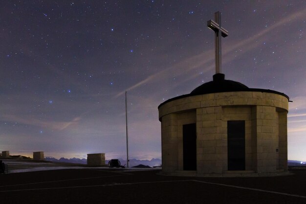 Monumento con cielo estrellado como fondo. Vista del monumento a los caídos en el Monte Grappa, punto de referencia italiano.