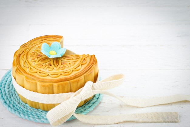 Mooncake chino decorado en el fondo de madera blanca