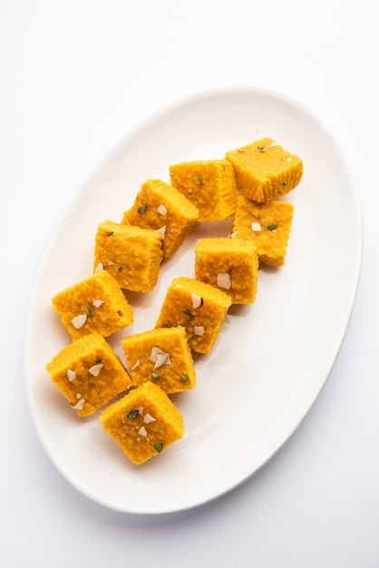 MoongÃ‚Â Dal Besan Burfi está hecho con moongÃ‚Â dal tostado o lentejas amarillas, harina de garbanzo, ghee, khoya o mawa y jarabe de azúcar, dulce o postre indio.