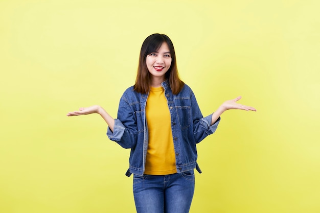 Morena asiática joven en la chaqueta jean sonriendo posando