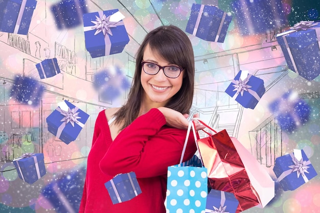 Morena sonriente sosteniendo bolsas de compras contra puntos brillantes de luz en azul