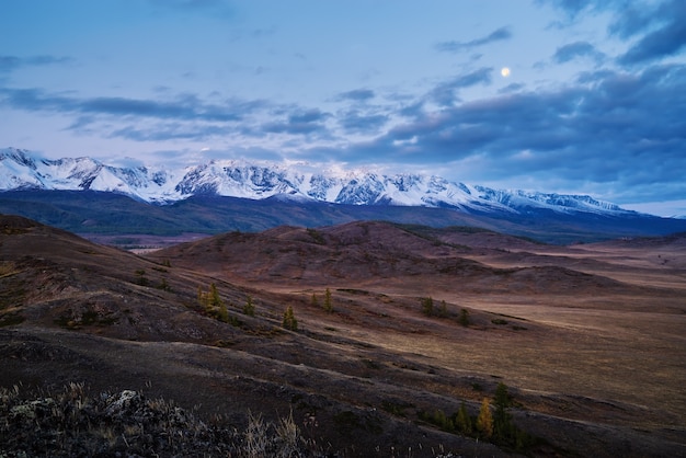 Morgens in der Kurai-Steppe, der Mond über dem Nord-Tschuisky-Kamm. Kosh-Agachsky District, Republik Altai, Russland