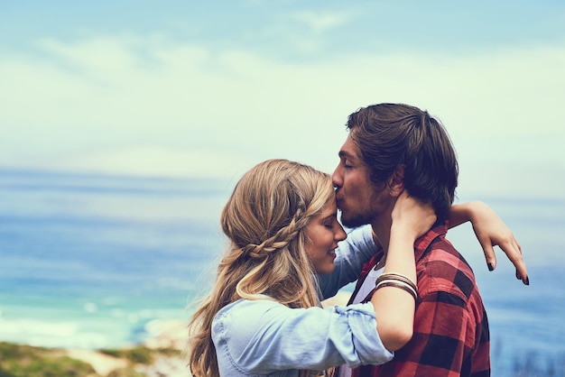 Mostrando seu afeto Foto de um jovem casal afetuoso desfrutando de uma caminhada nas montanhas