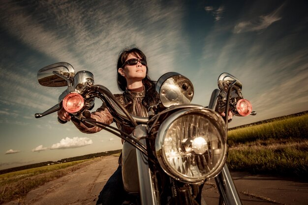 Foto motociclista em uma jaqueta de couro em uma motocicleta