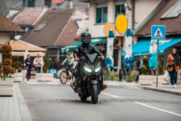 Un motociclista moderno conduce una motocicleta por la carretera de la ciudad