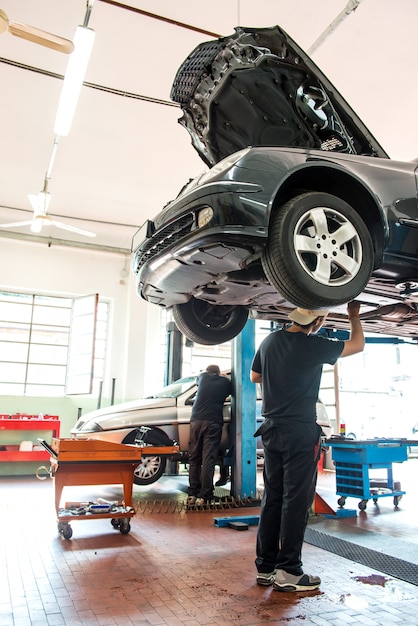 Motor mecánico trabajando en un automóvil en un polipasto