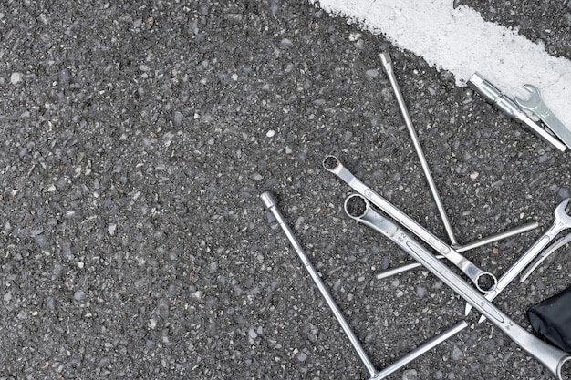 Motorradreparaturwerkzeuge auf der Straße. Ansicht von oben. flach liegen