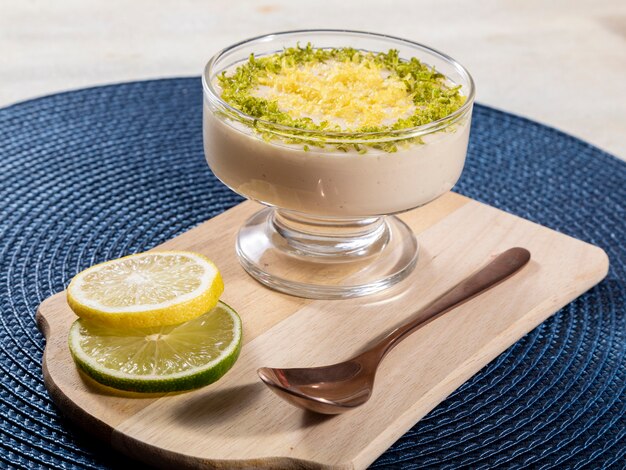 Mousse de limón en cuenco de cristal con ralladura de limón.