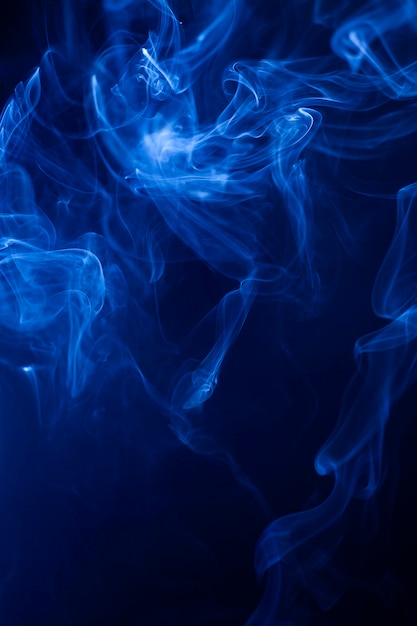 Movimento fumaça azul sobre fundo preto.