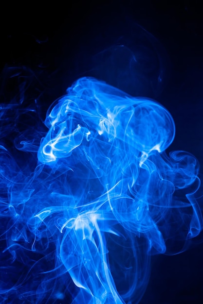 Movimiento de humo azul sobre fondo negro