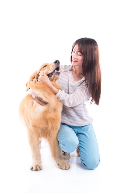 Muchacha asiática hermosa con el perro del golden retriever aislado sobre el fondo blanco