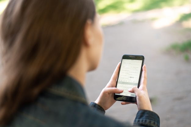 Muchacha femenina joven con smartphone