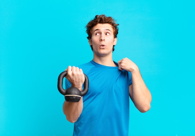 Muchacho joven del deporte que se siente estresado, ansioso, cansado y frustrado, tirando del cuello de la camisa, luciendo frustrado con el problema. concepto de mancuernas