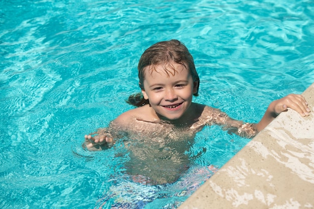 Muchacho Practicar la natación Niño lindo nadar en la piscina fondo de agua de verano con espacio de copia Cara divertida de los niños