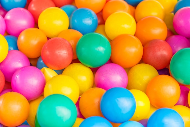 Muchas bolas de plástico de colores en una bolera para niños en un parque infantil