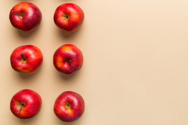 Muchas manzanas rojas en fondo coloreado vista superior patrón de otoño con manzana fresca vista superior con espacio de copia para diseño o texto