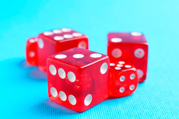 Muchos dados de juego rojos en primer plano de fondo azul claro