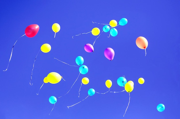 Foto muchos globos multicolores volando en el cielo azul accesorios y decoraciones de vacaciones