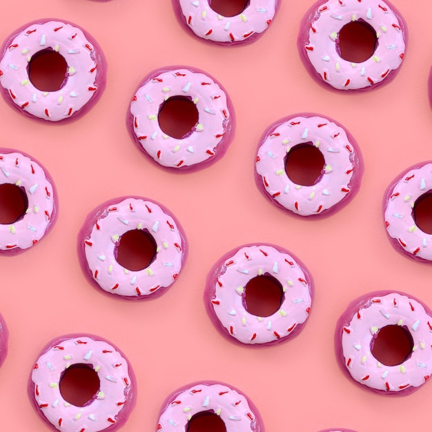 Muchos pequeños donuts de plástico se encuentra en un fondo de colores pastel