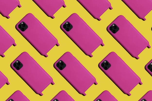 Foto muchos teléfonos de color rosa brillante sobre un fondo amarillo