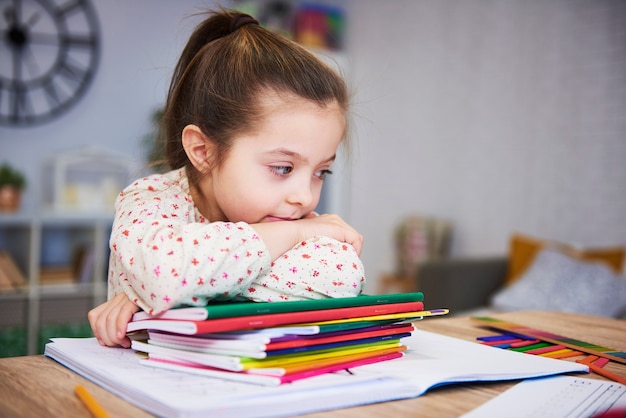 Müder und gelangweilter Student mit Stapel Büchern