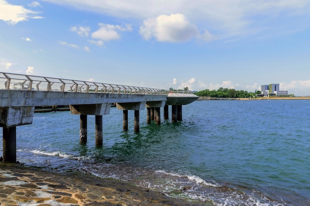 Muelle de puente de hormigón que se extiende hacia el mar.