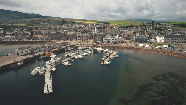 Foto muelle de sol con yates aéreos paisaje urbano de verano del puerto de la ciudad de campbeltown escocia europa