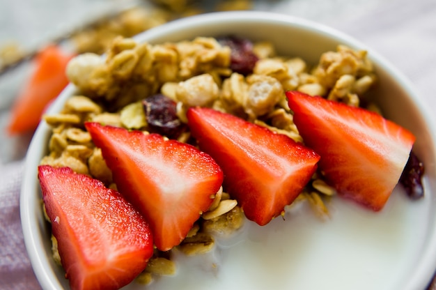 Müslischale mit Müsli, Erdbeeren und Joghurt.