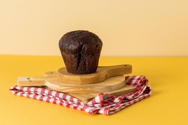 Muffin de chocolate delicioso caseiro em tábuas de corte de madeira Sobremesa saborosa guardanapo vermelho horizontal
