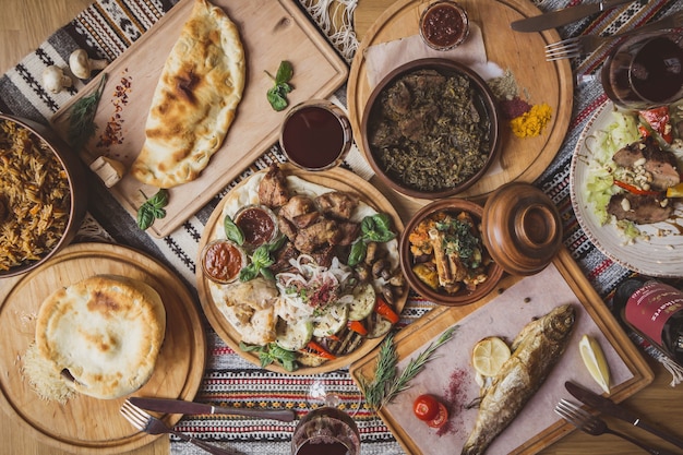 Muita comida na mesa de madeira. Cozinha georgiana. Pratos khinkali e georgianos