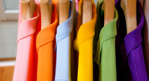 Foto muitas camisas coloridas penduradas em um rack
