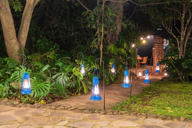 Muitas lâmpadas de querosene iluminam a estrada no jardim tropical. tanzânia, áfrica