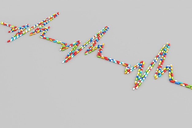 Muitos comprimidos espalhados sob a forma de um eletrocardiograma do coração do paciente