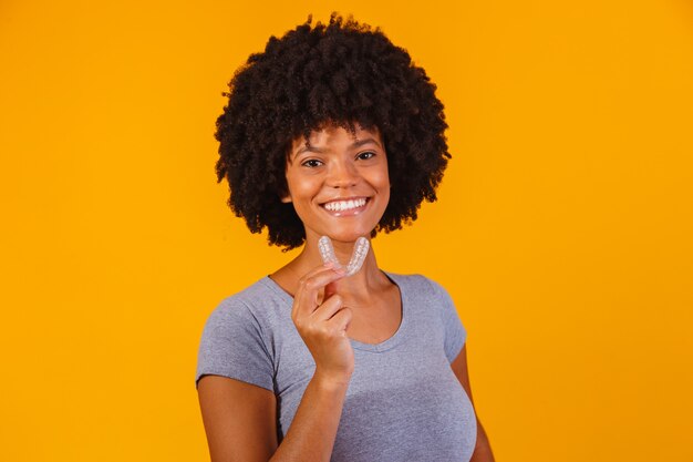 Mujer afro con placa blanqueadora. Dispositivo invisible.