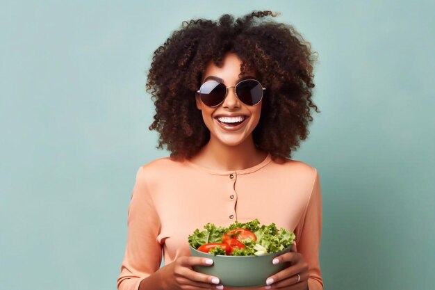 Mujer afroamericana comiendo ensalada de verduras sobre un fondo claro con espacio de copia