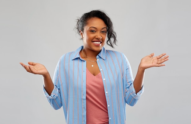 Una mujer afroamericana sin idea se encoge de hombros.