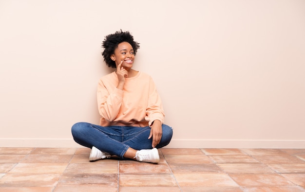 Mujer afroamericana sentada en el piso