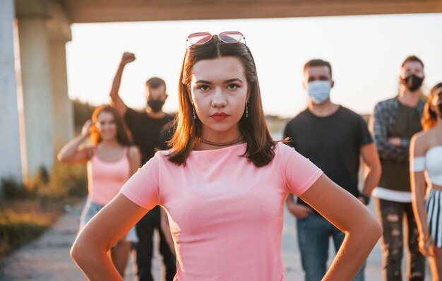 Foto mujer al frente de la multitud grupo de jóvenes que protestan que se unen activista por los derechos humanos o contra el gobierno