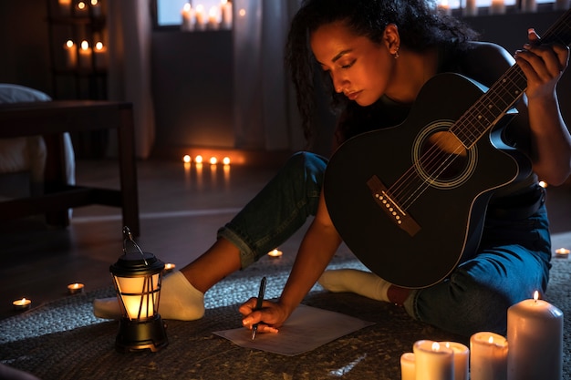 Foto mujer de alto ángulo haciendo música con guitarra