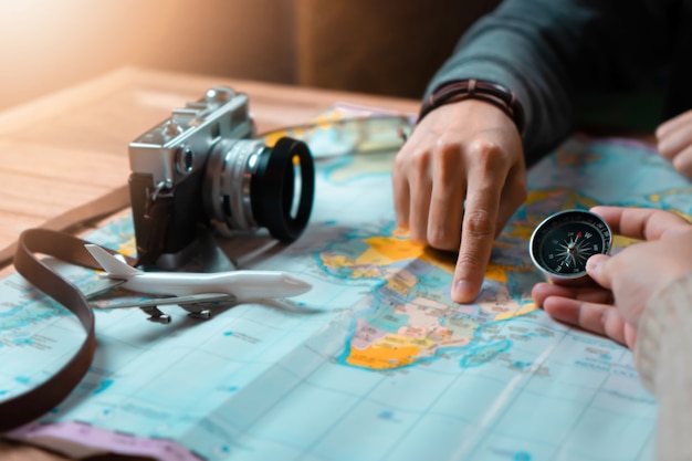 Foto mujer con amiga planeando viaje de vacaciones con accesorios de viajero