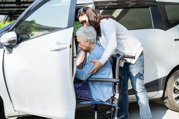 Mujer anciana asiática paciente sentada en silla de ruedas prepararse para llegar a su coche