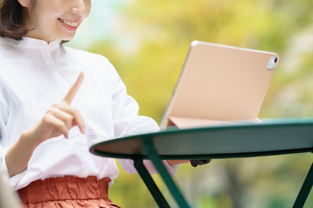 Mujer anónima con un tablet PC al aire libre