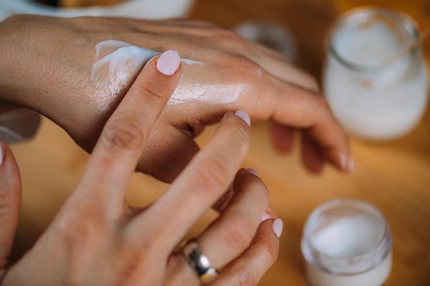 Foto mujer aplicando crema para manos casera en sus manos