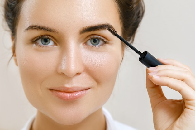 Mujer aplicando gel de cejas teñidas