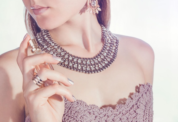 Mujer aplicando perfume en su cuello