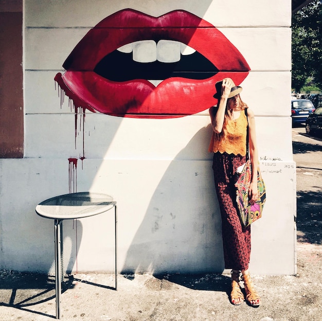 Foto mujer apoyada en la pared