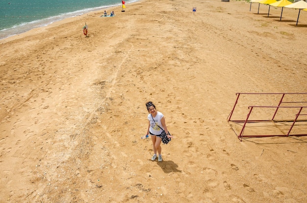 Una mujer en la arena de la playa en un día de verano.